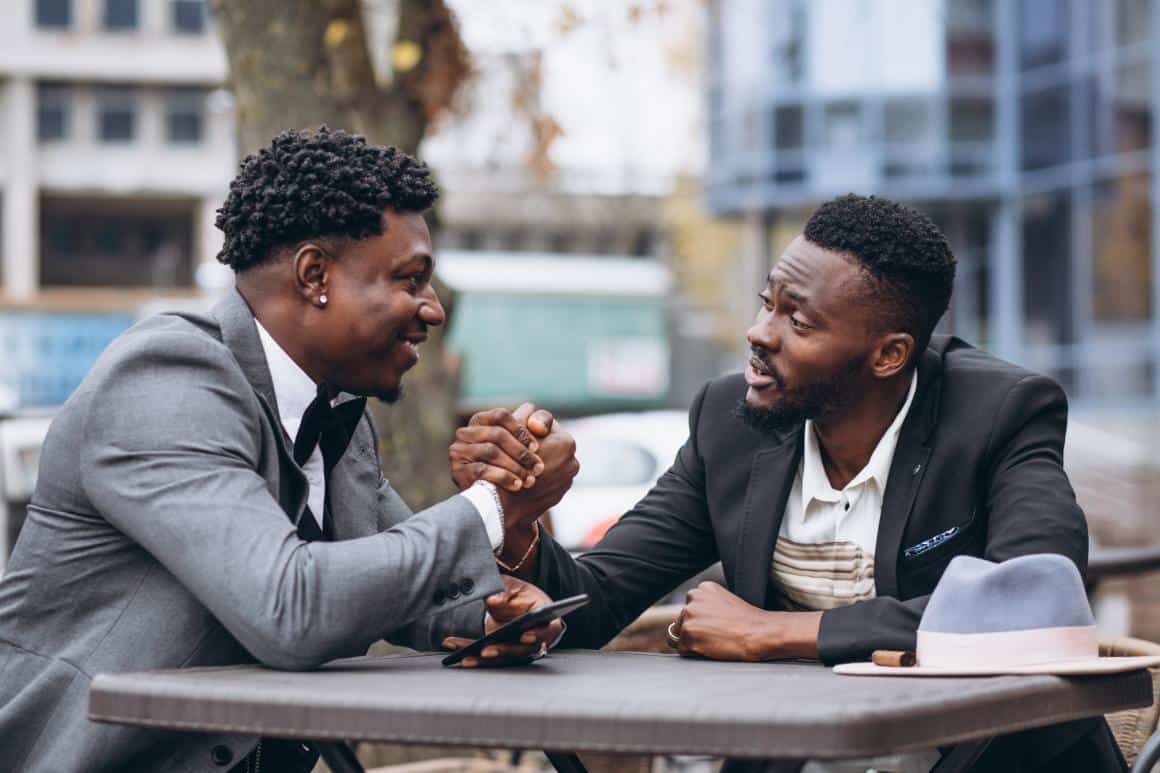 two-african-businessman-sitting-outside-cafe